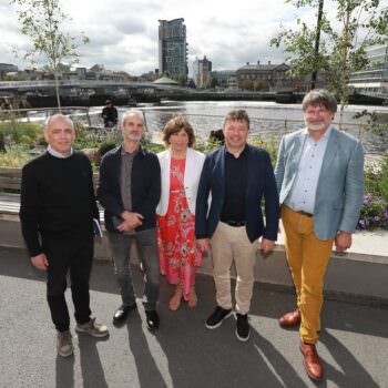 Members of the Waterfront Design Panel photographed on Queens Quay with the River Lagan in the backdrop